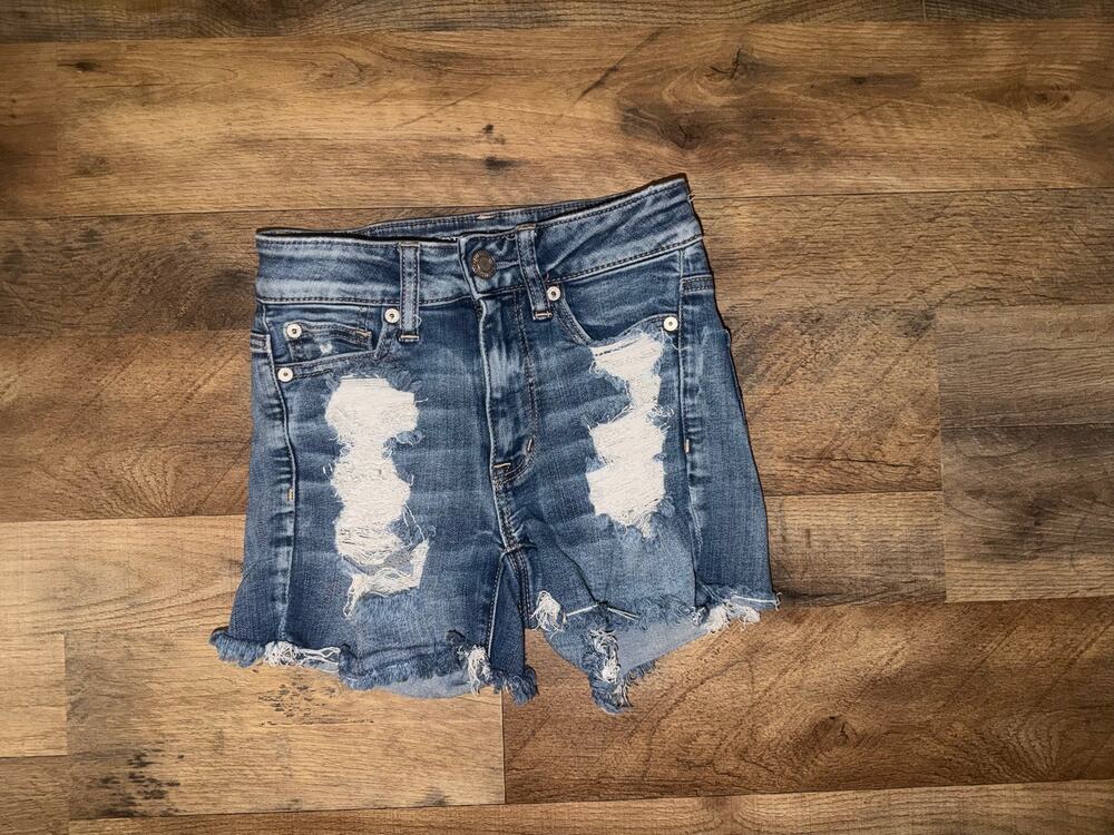 American Eagle womenโs next level stretch x distressed blue jeans shortie